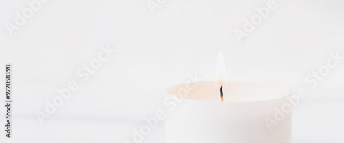 White Candle With Flame On White Background
