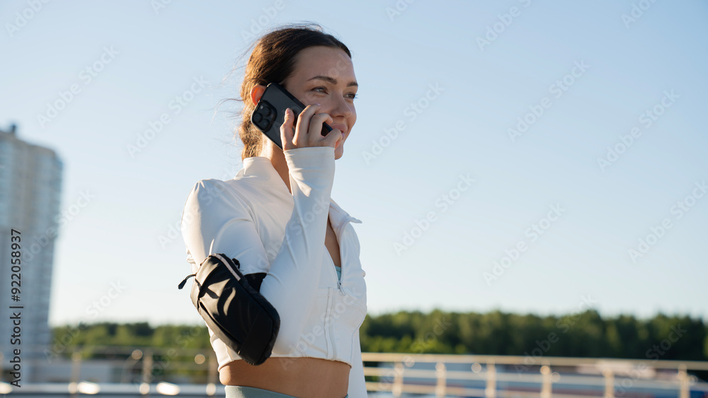 Beautiful woman exercising fitness and talking to mobile phone Beautiful woman exercising fitness and talking to mobile phone