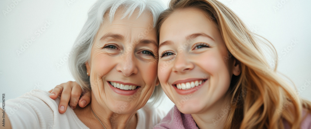 Happy grandmother and granddaughter smiling together Happy grandmother and granddaughter smiling together