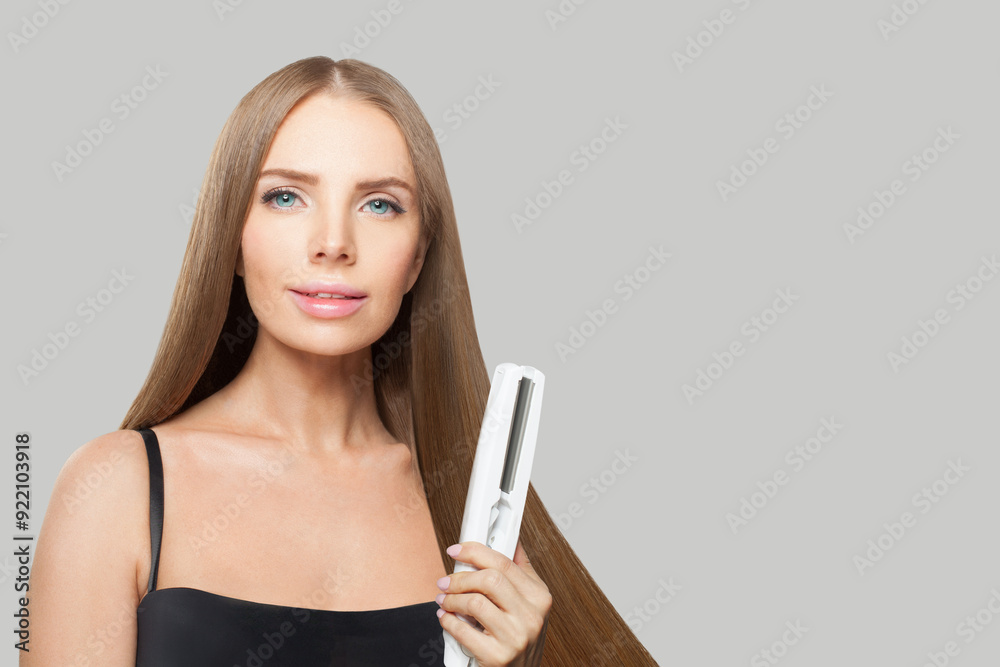 Fashionable woman with long hair using a straight hair iron and doing a hairstyle, beauty, care and fashion concept Fashionable woman with long hair using a straight hair iron and doing a hairstyle, beauty, care and fashion concept