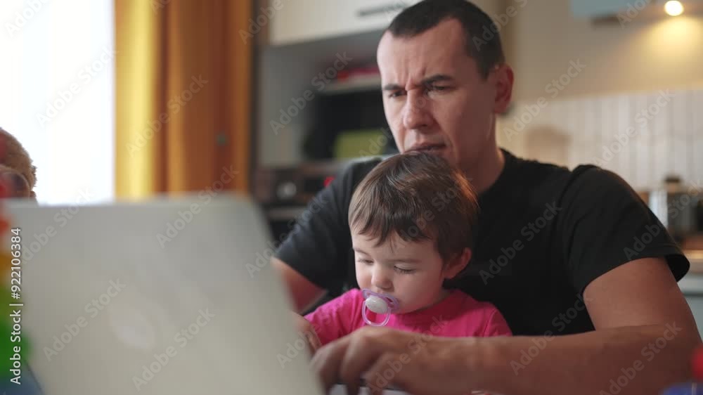 father working from home a remotely with baby daughter in his arms. pandemic remote work business concept. father tries to work at home in kitchen, baby children fun interfere sitting on their hands father working from home a remotely with baby daughter in his arms. pandemic remote work business concept. father tries to work at home in kitchen, baby children fun interfere sitting on their hands