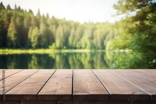 The empty wooden table top with blur background of summer lakes green forest