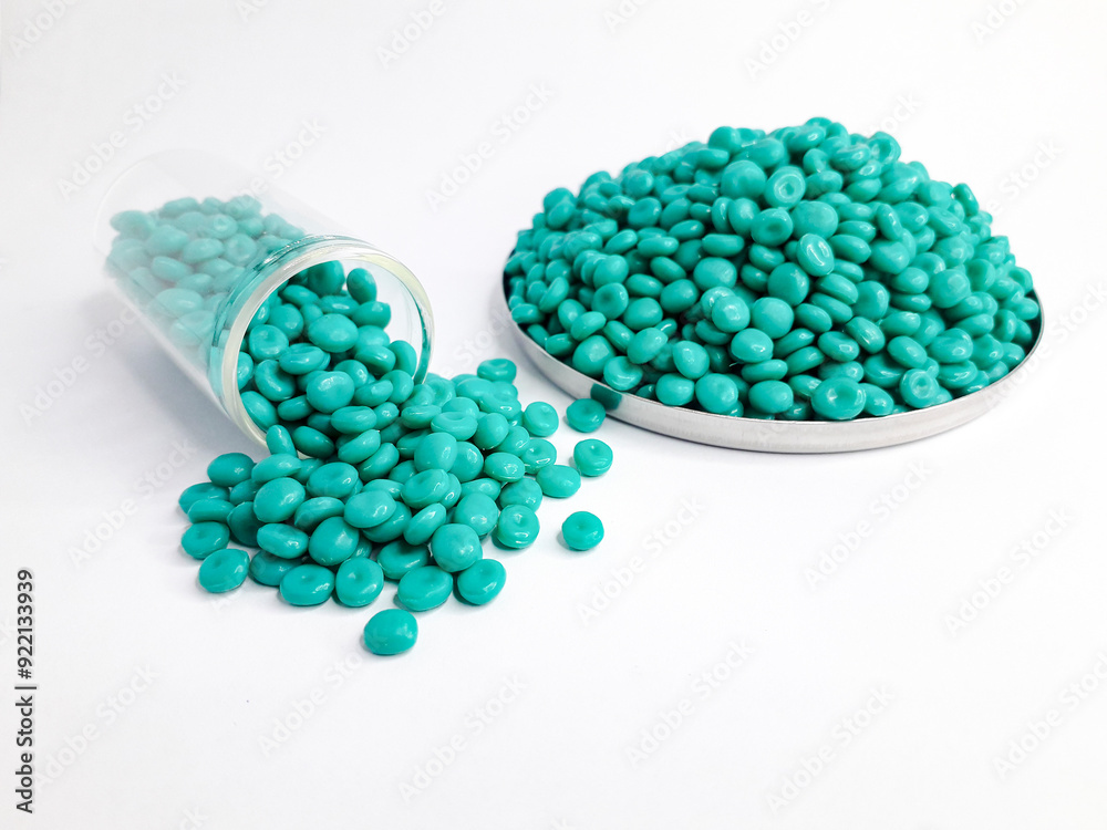 Aruba blue masterbatch granules on white background. Color pigment carrier polymer in plastic industry Aruba blue masterbatch granules on white background. Color pigment carrier polymer in plastic industry