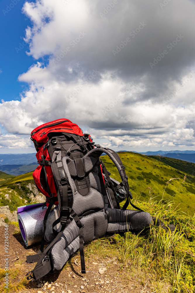 Obraz premium Hiking in the mountains with a backpack in summer.