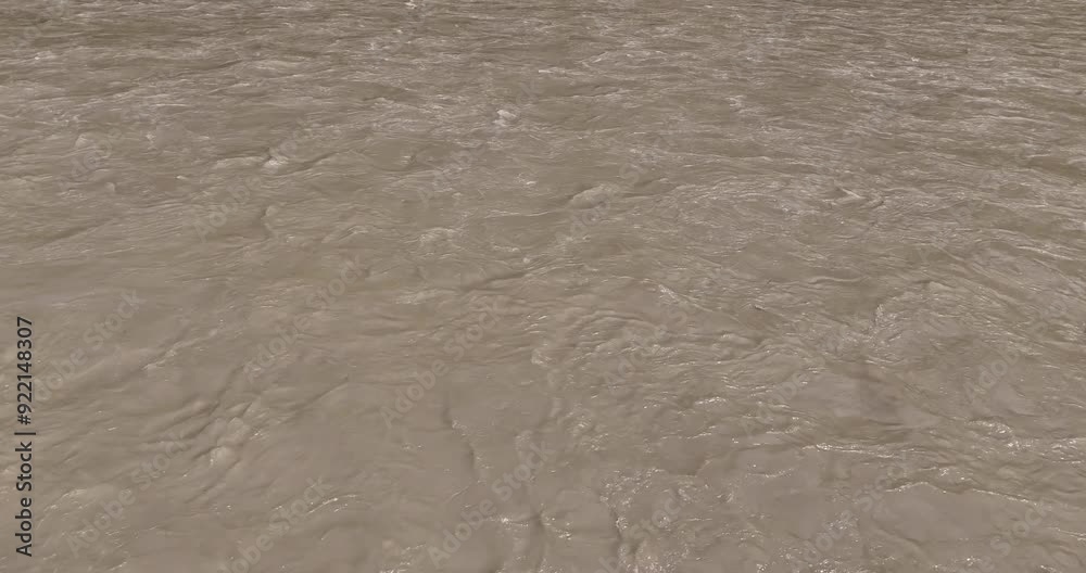 Landscape drone shot of a river during monsoon in Nepal, with heavy rainfall causing flooding on a sunny day. The riverbank is lined with a vast forest of lush greenery. Landscape drone shot of a river during monsoon in Nepal, with heavy rainfall causing flooding on a sunny day. The riverbank is lined with a vast forest of lush greenery.
