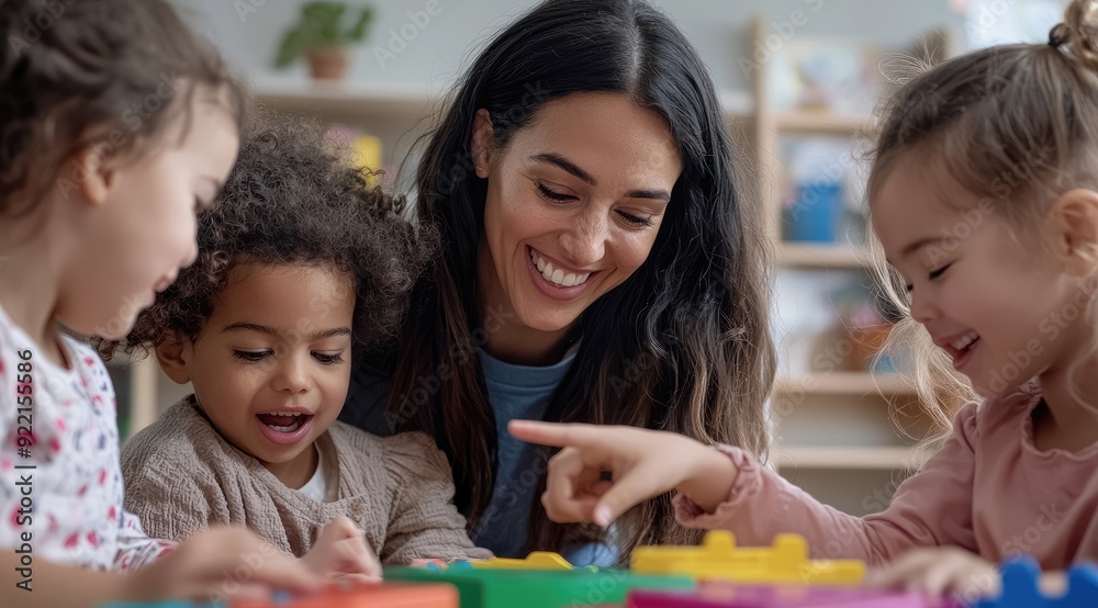 Smiling Teacher Engaging with Diverse Preschool Children During Playtime Smiling Teacher Engaging with Diverse Preschool Children During Playtime