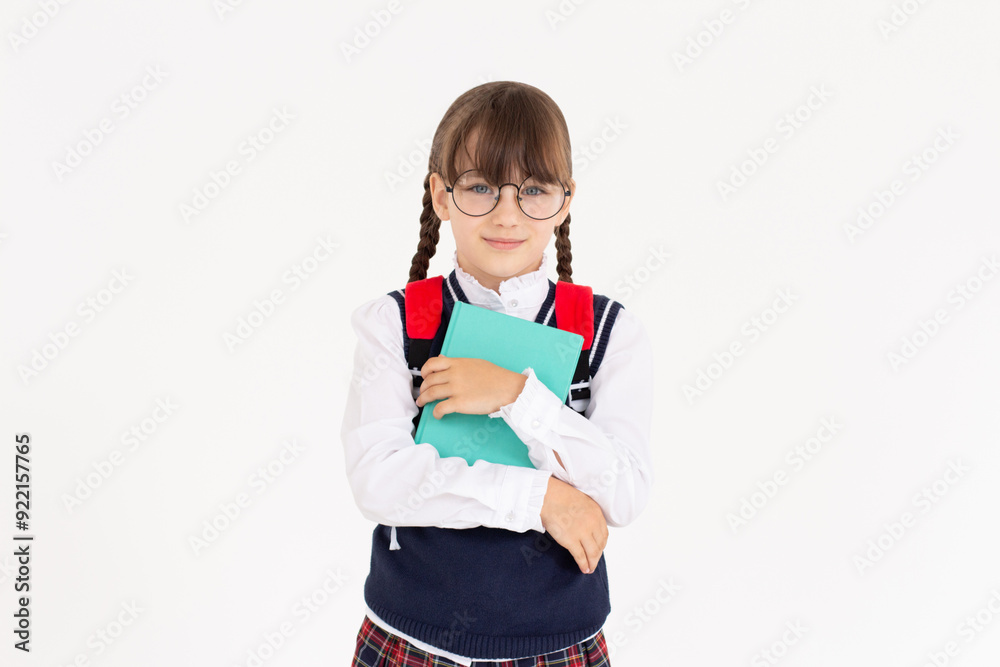An engaged teen girl looks excited, hugging book, capturing a moment of epiphany or getting an idea, isolated on white An engaged teen girl looks excited, hugging book, capturing a moment of epiphany or getting an idea, isolated on white