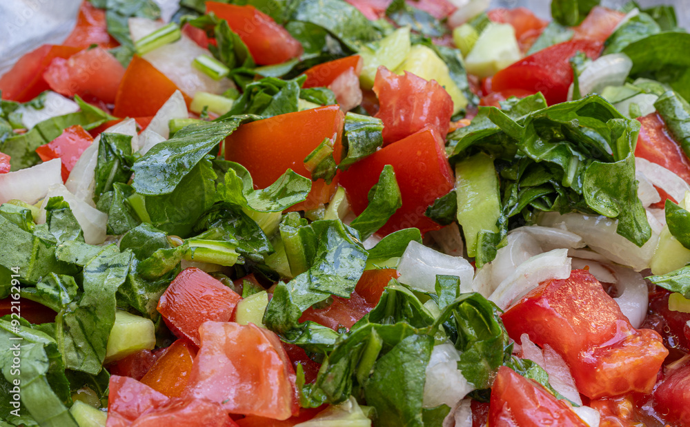 Seasonal salad. Mediterranean salad with tomatoes, peppers, onions, arugula and olive oil.