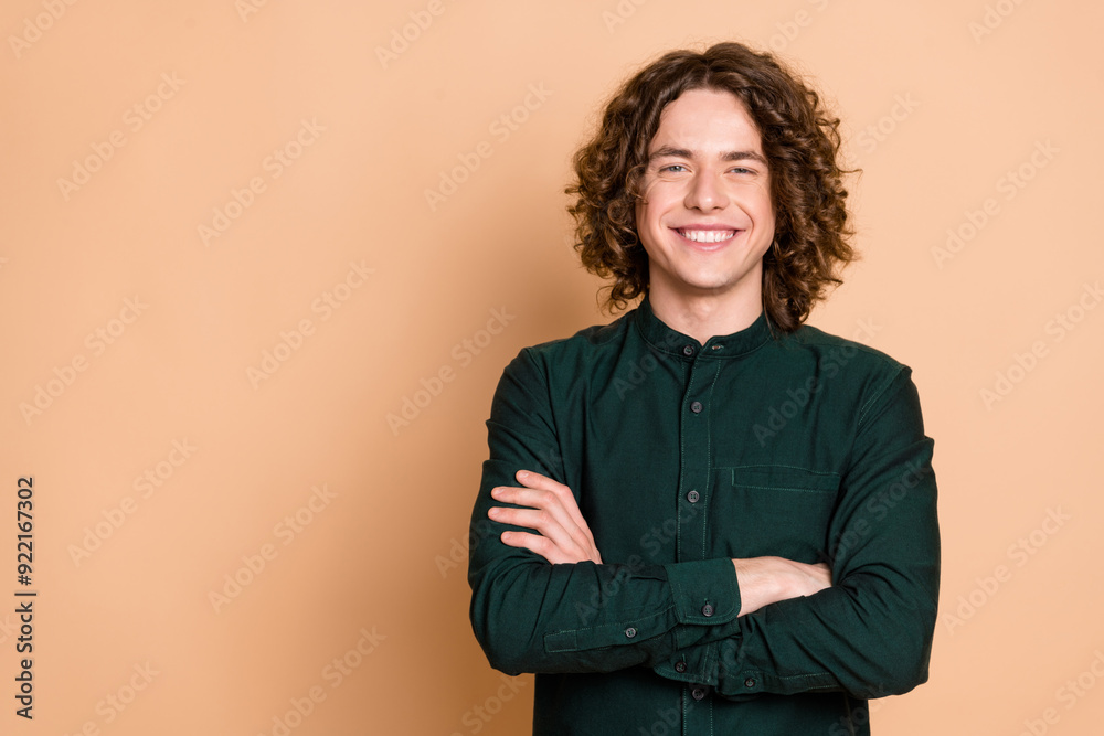 Photo portrait of handsome young guy crossed hands confident pose dressed stylish green garment isolated on beige color background Photo portrait of handsome young guy crossed hands confident pose dressed stylish green garment isolated on beige color background