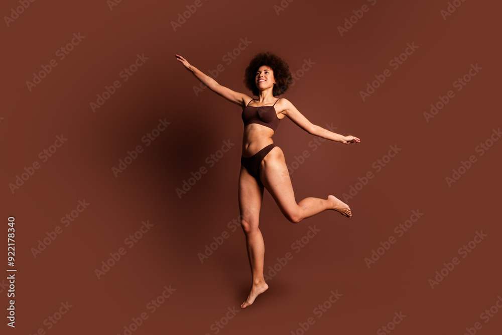 Full length photo of funky carefree lady underwear jumping loving body positive isolated brown color background Full length photo of funky carefree lady underwear jumping loving body positive isolated brown color background