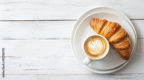 Coffee Cup and Croissant on Plate with White Wood Background - Top View with Space for Text photo