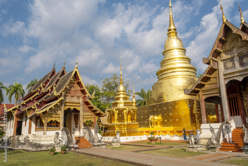 Naklejka premium Wihan Lai Kham temple and the Chedi Phrathatluang in the Wat Phra Singh Temple in Chiang Mai, Thailand 