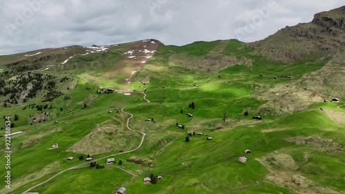 Aerial view of the rocky peaks of the Seceda Mountain touching the clouds in the Dolomites, Italy