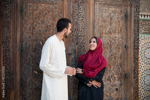 Young Muslim couple in relationship talking and smiling