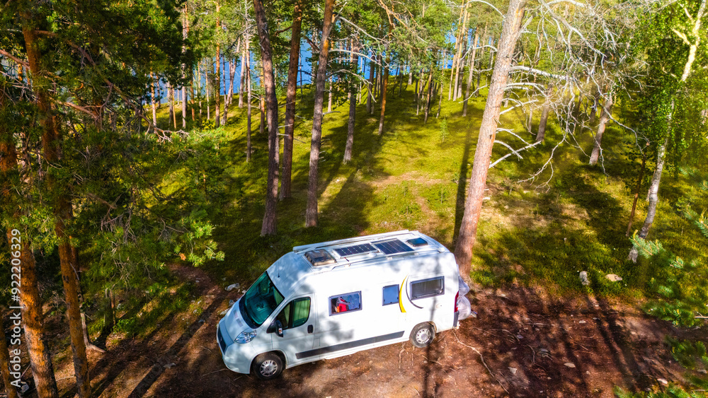Embark on a scenic camper van journey through Norways lush forests, near tranquil and serene waters Embark on a scenic camper van journey through Norways lush forests, near tranquil and serene waters