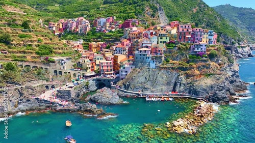 Cinque terra aerial view on a sunny day, Italian riviera, drone view of Cinque Terre, Manarola fishing village in Italy, holiday on Ligurian coast