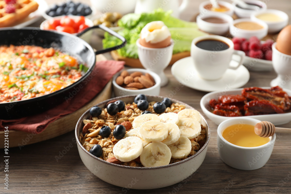 Different meals served for breakfast on wooden table Different meals served for breakfast on wooden table