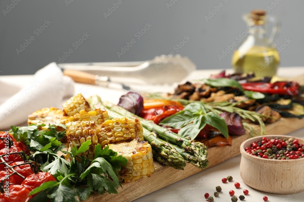 Delicious grilled vegetables with spices on white table, closeup Delicious grilled vegetables with spices on white table, closeup