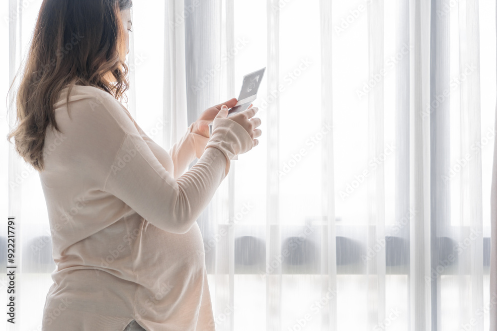 Pregnant asian woman holding ultrasound baby Image Result from Doctor. Happy mom health care concept Pregnant asian woman holding ultrasound baby Image Result from Doctor. Happy mom health care concept