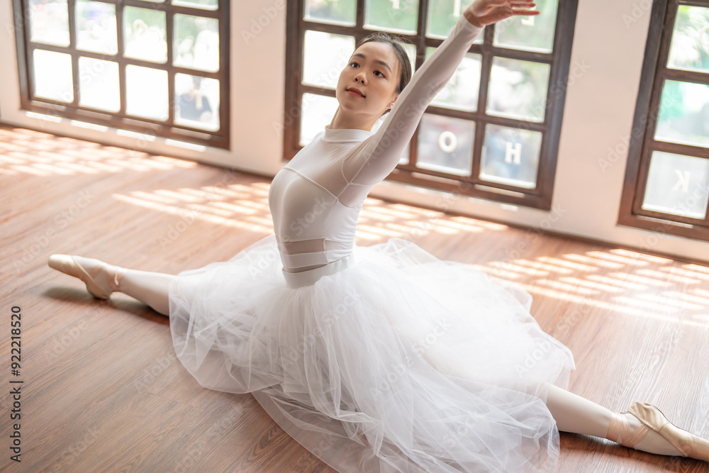 Asian girl ballet dancer gymnastic exercises in studio for body flexibility Ballerina training stretches her leg and prepares for performance practice routine. Asian girl ballet dancer gymnastic exercises in studio for body flexibility Ballerina training stretches her leg and prepares for performance practice routine.