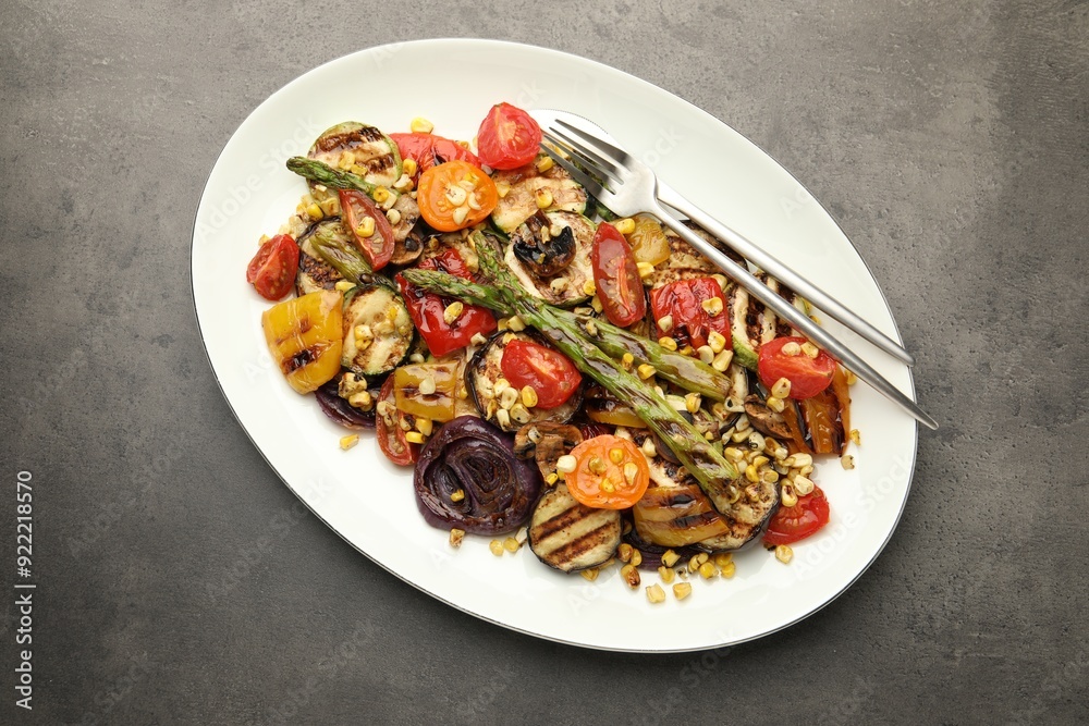 Delicious salad with grilled vegetables served on gray textured table, top view Delicious salad with grilled vegetables served on gray textured table, top view