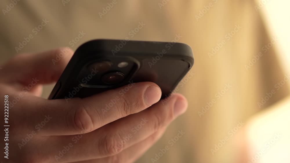 a man holding a smartphone in his hand and reading a message a man holding a smartphone in his hand and reading a message