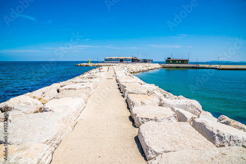 A view along the top of the harbour breakwater at Rimini, Italy in summertime