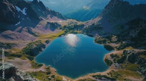 Aerial view of a serene mountain lake surrounded by peaks, with space for text in the upper part photo