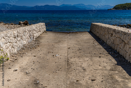 Wild rocky beach with palm trees on the Adriatic Sea on the Peljesac Peninsula Luka Beach photo