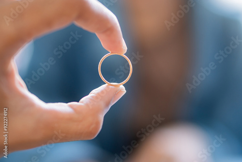 Close-Up of a Hand Holding a Gold Ring