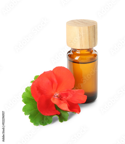 Bottle of geranium essential oil and beautiful flower isolated on white