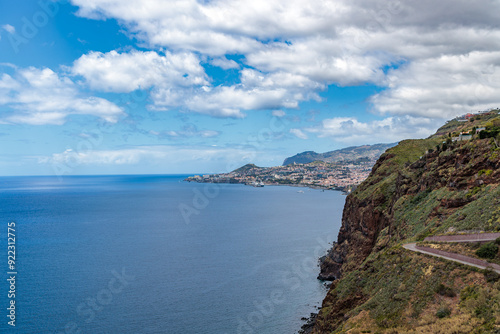 Cristo Rei. Jesus monument on top of a cliff overlooking the Atlantic Ocean and a cable car leading down to the beach on the island of Madeira