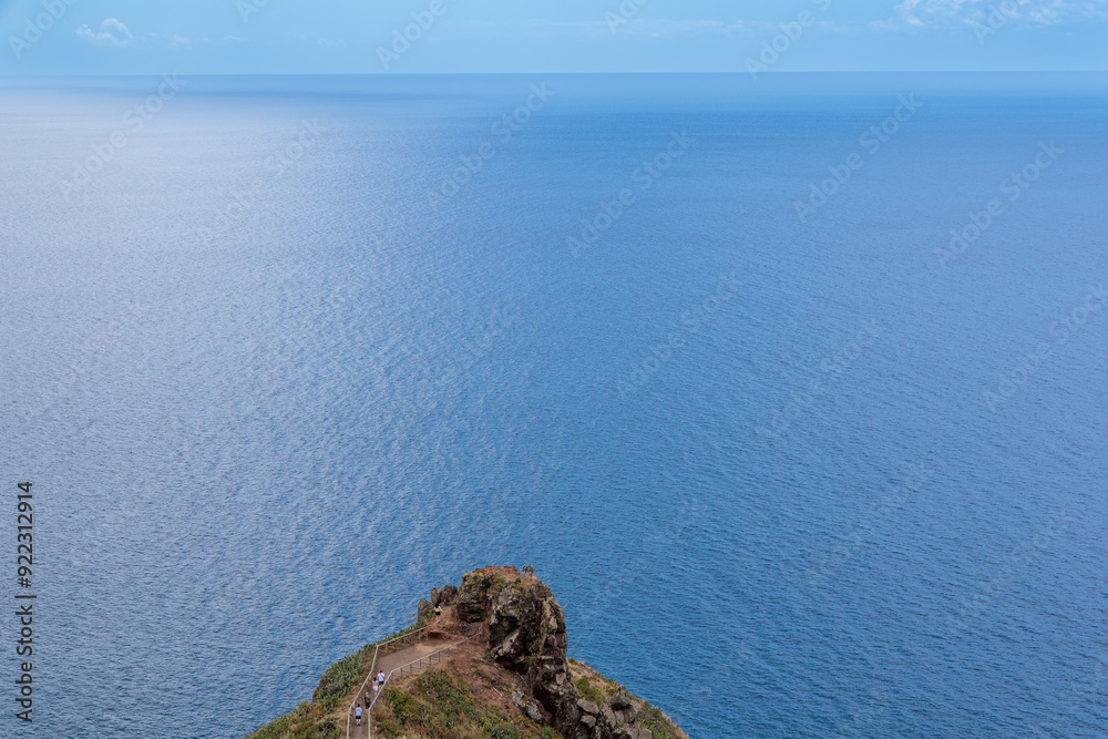 Cristo Rei. Jesus monument on top of a cliff overlooking the Atlantic Ocean and a cable car leading down to the beach on the island of Madeira