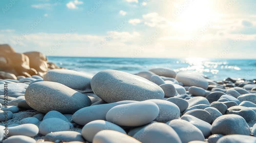 Huge grey stones on the beach. The sun is sharply shining. Huge grey stones on the beach. The sun is sharply shining.