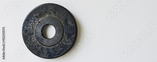 Minimalist weightlifting, single weight plate, white background, natural light