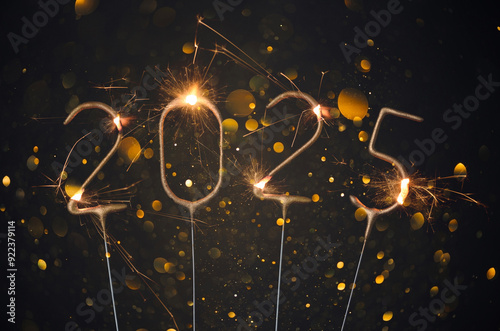 2025 Happy new year Silvester greeting card with burning golden sparklers shiny glitter lights bokeh