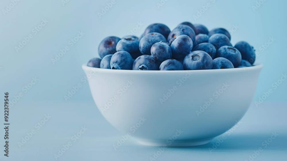 Freshly Picked Blueberries in a White Ceramic Bowl on a Light Blue Background Perfect for Healthy Eating and Food Photography Trends in 2023 Freshly Picked Blueberries in a White Ceramic Bowl on a Light Blue Background Perfect for Healthy Eating and Food Photography Trends in 2023