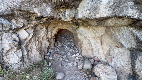 Rocks strewn near cave entrance photo