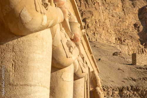 The statue of Osiris guardian and watchman of the entrance of the temple of Hatshepsut. This imposing figure symbolizes the divine protection granted to the pharaoh and her eternal resting place. photo