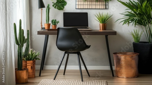 Designer black chair at desk with laptop.