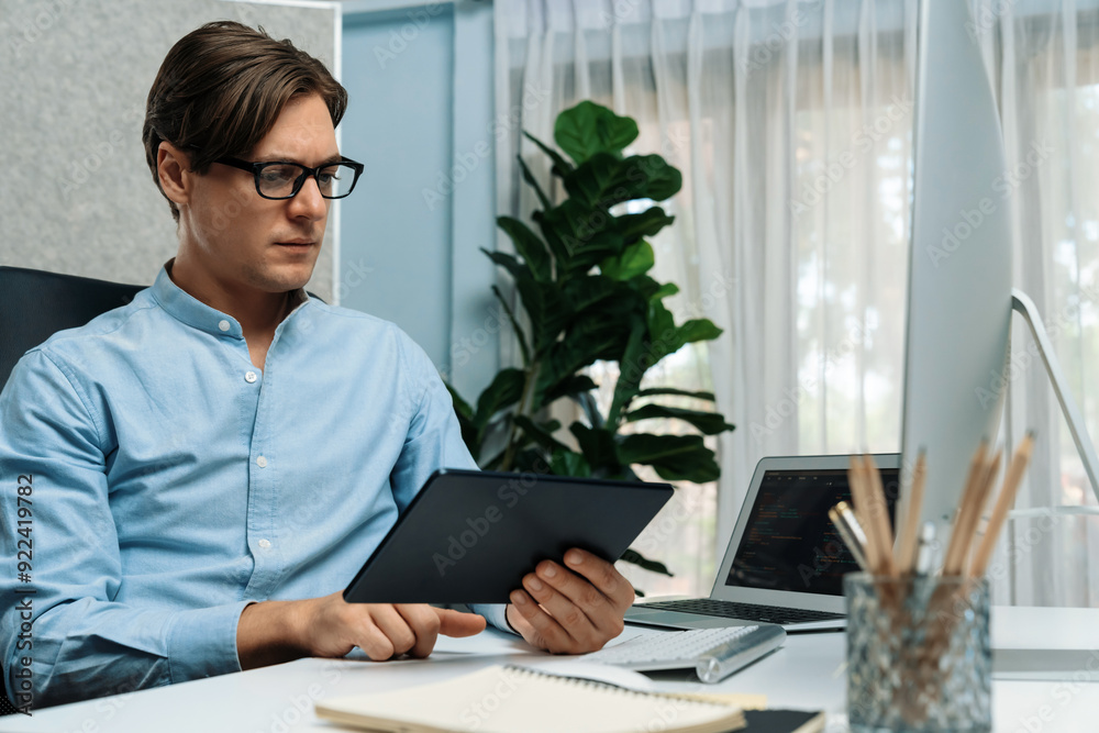 Fototapeta premium IT developer selecting by point on coding online software development information on tablet comparing with pc and laptop screen with new code program on update version overall system. Pecuniary.