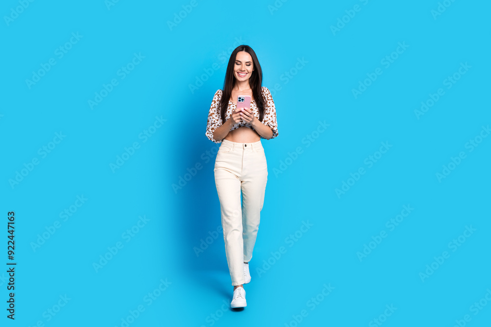 Photo of adorable lovely gorgeous woman wear stylish summer print clothes read comment isolated on blue color background Photo of adorable lovely gorgeous woman wear stylish summer print clothes read comment isolated on blue color background