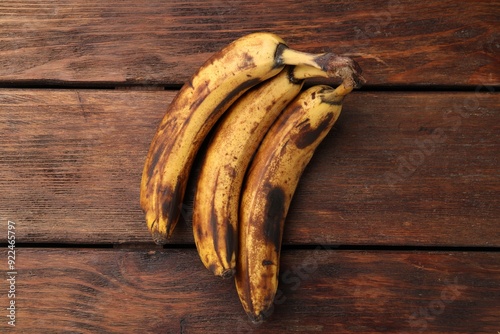 Konstfotografi Bunch of ripe bananas with dark spots on wooden table, top view