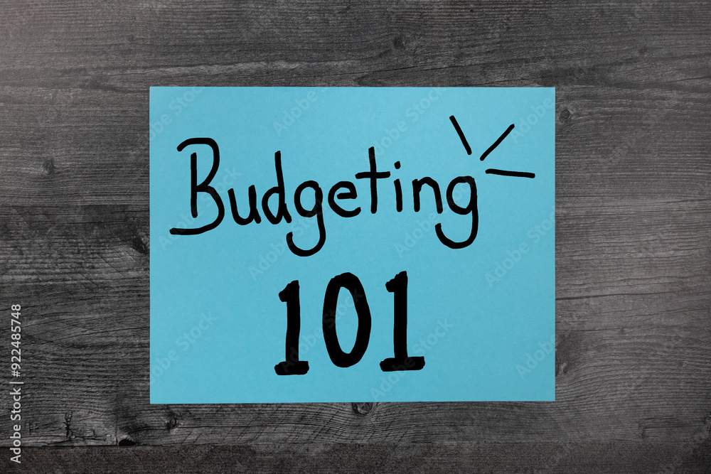 Budgeting 101 hand written on blue paper flat lay background 