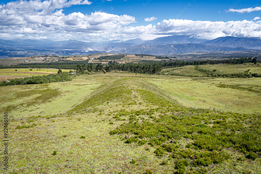 Fototapeta premium Fields, meadows and plants of the Cochasqui Pyramids Park, in Tabacundo Ecuador, on a beautiful sunny afternoon