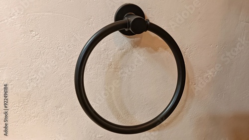 Obraz na plátně A black towel ring is hanging on a wall