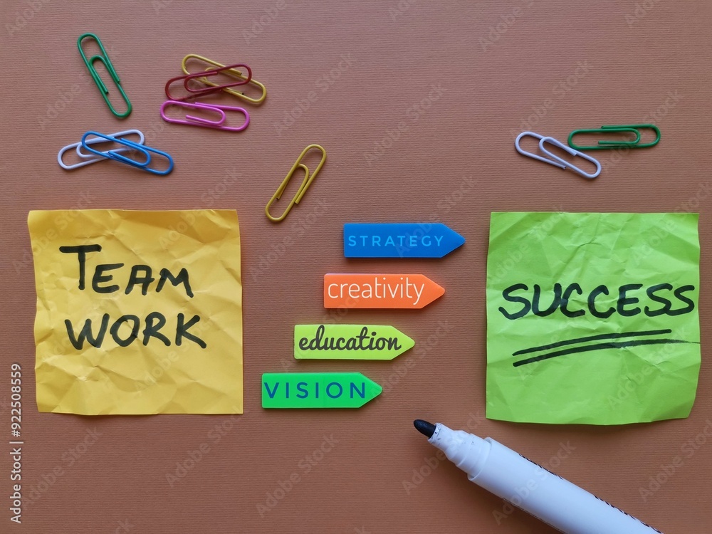 Task concept, business plan of the words Teamwork, Education, Vision, Creativity, Strategy, Success written on colorful sticky notes. Planning a strategy on colored paper with paper clips and marker Task concept, business plan of the words Teamwork, Education, Vision, Creativity, Strategy, Success written on colorful sticky notes. Planning a strategy on colored paper with paper clips and marker