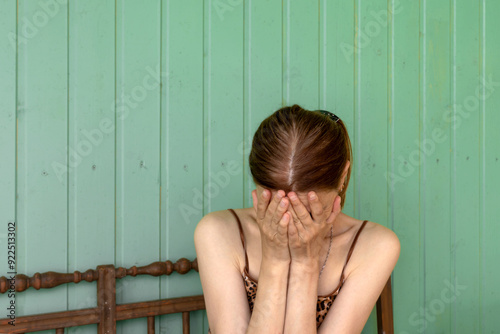 Tableau sur toile An unrecognizable young woman covered her face with her palms, expressing despair and sorrow