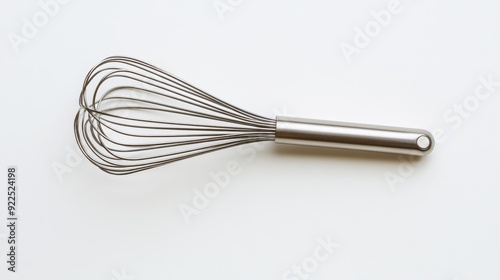 Stainless steel whisk isolated on a white background, showcasing sleek design and functionality in modern kitchen tools.