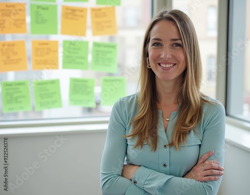 Professional Woman Smiling in Front of Note-Laden Wall. Free Download Professional Woman Smiling in Front of Note-Laden Wall. - GFXLoad